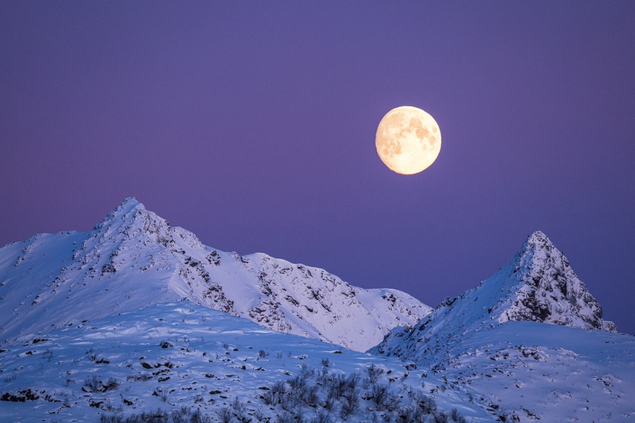 Snow covered mountains with clear moonlight