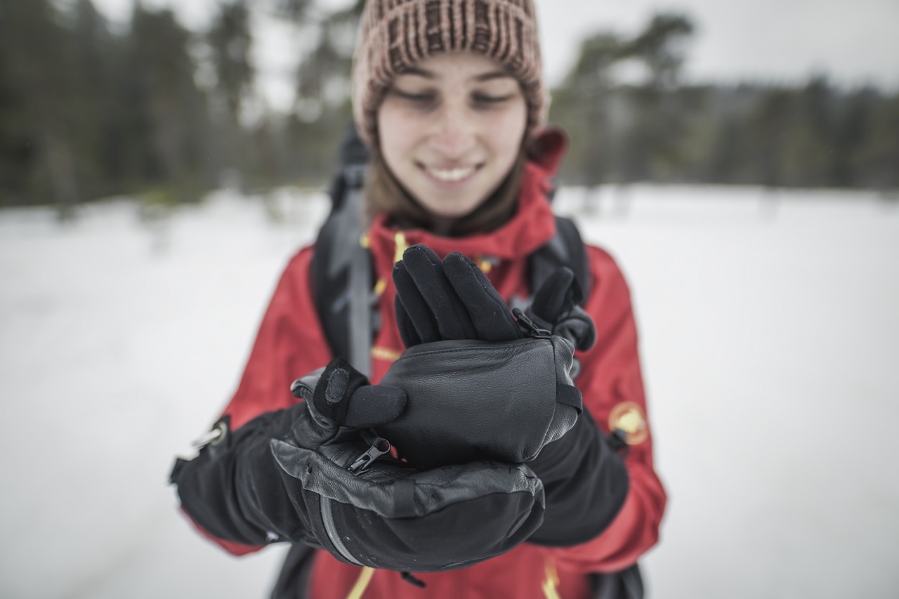 Woman wears finger gloves and mitten over it