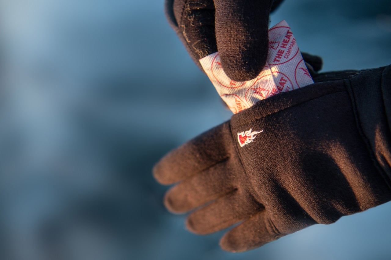 Black liner glove with a hand warmer