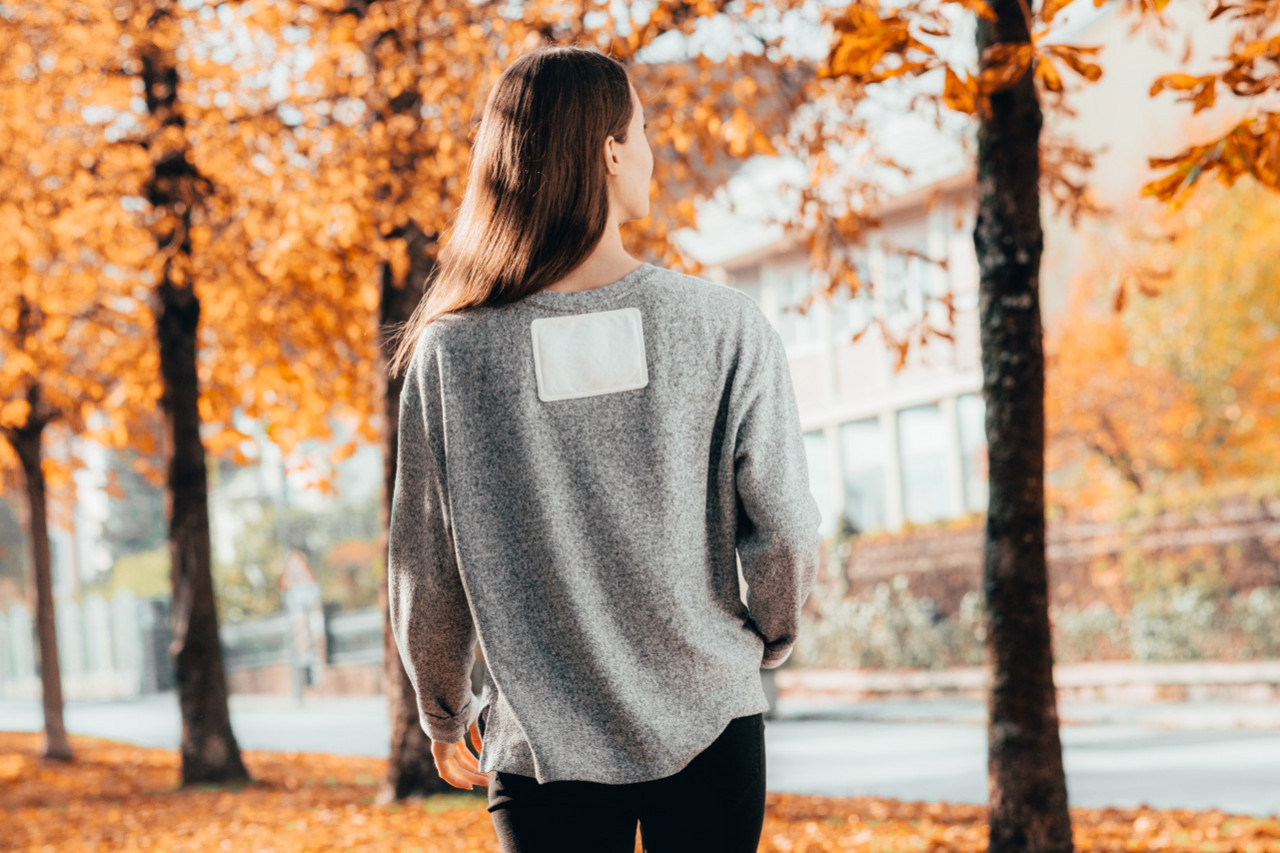 Woman wearing air activated neck warme