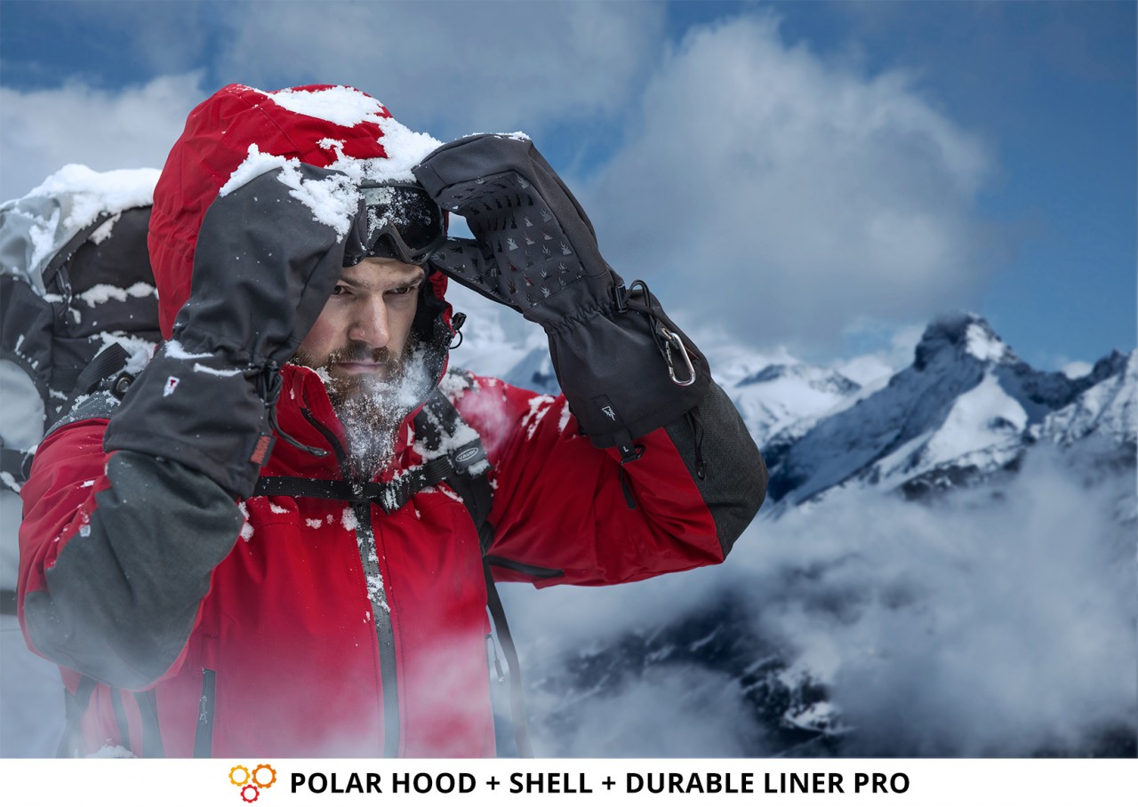 Pro Mountaineer using polar hood gloves to protect his shell from extreme weather conditions