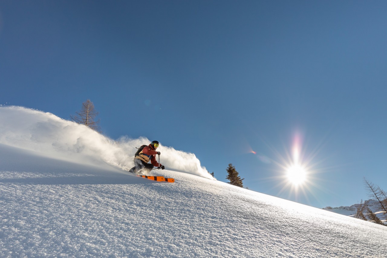 Person skiing in the mountains on a sunny day