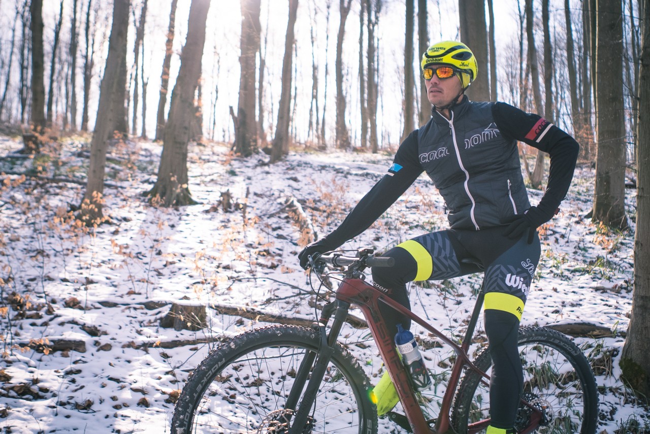 road cyclist in winter forest