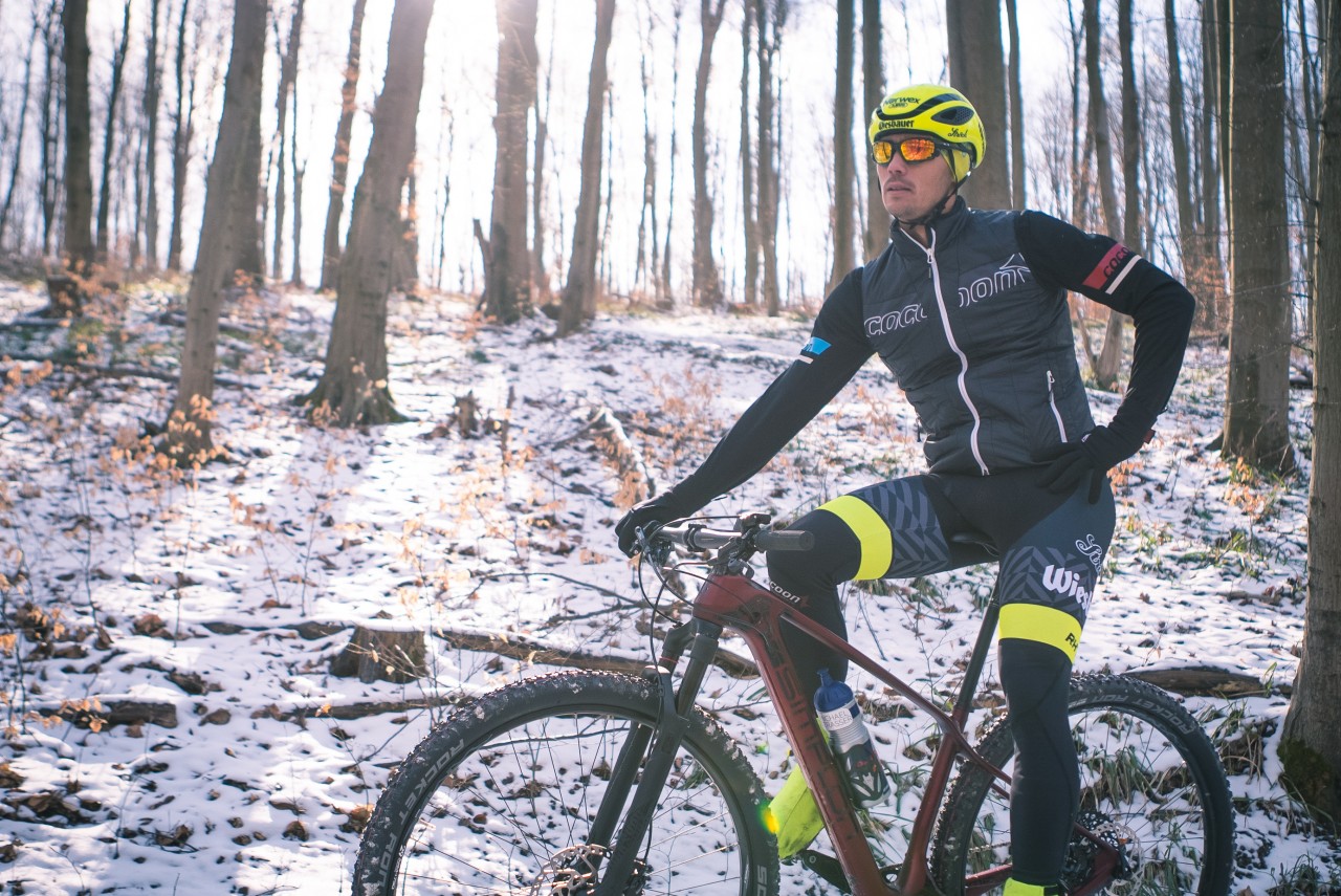 Ciclista de carretera en bosque invernal