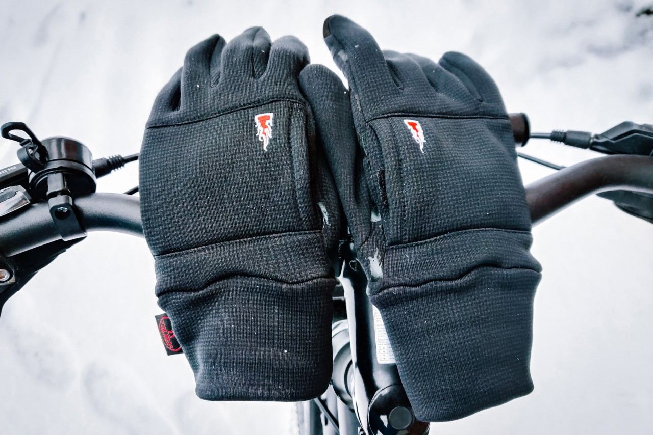 Liner finger gloves lying on bicycle handlebars
