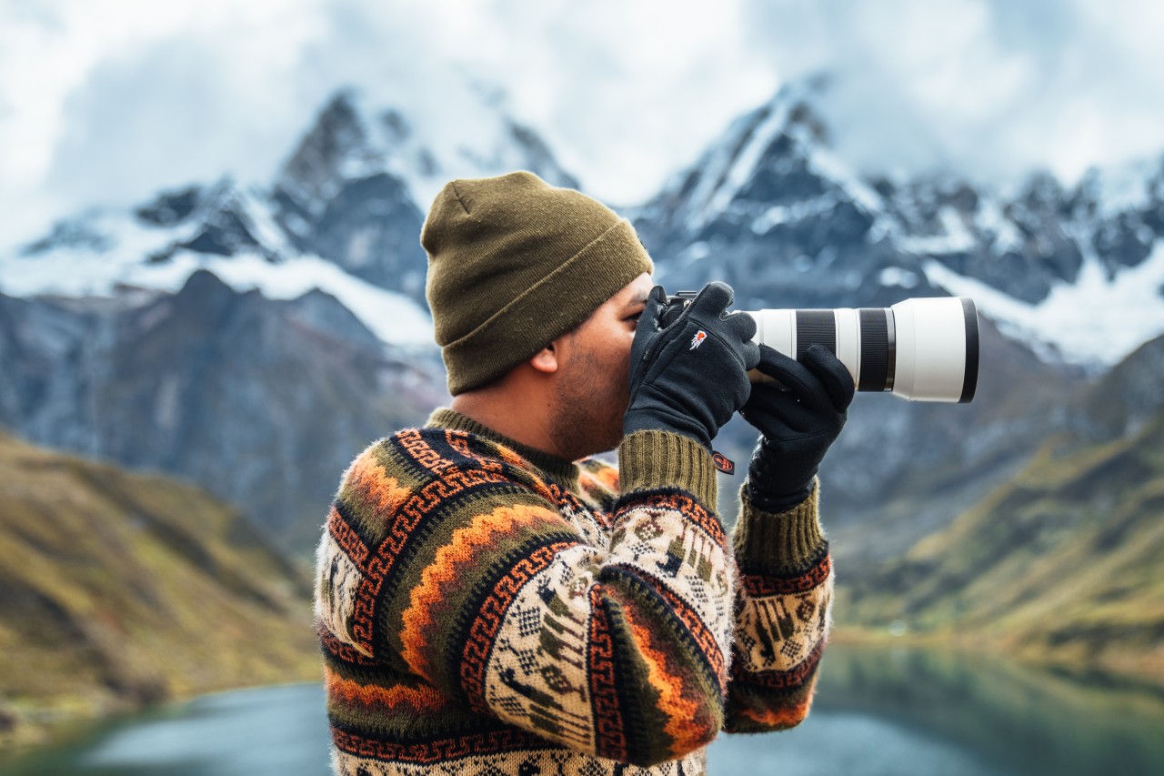 Man with gloves with camera in hand 