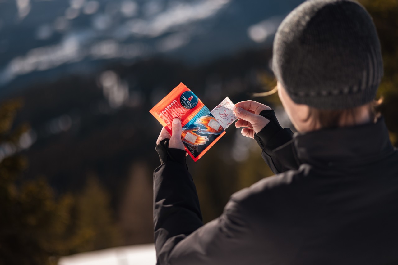 Man removing hand warmers from the package