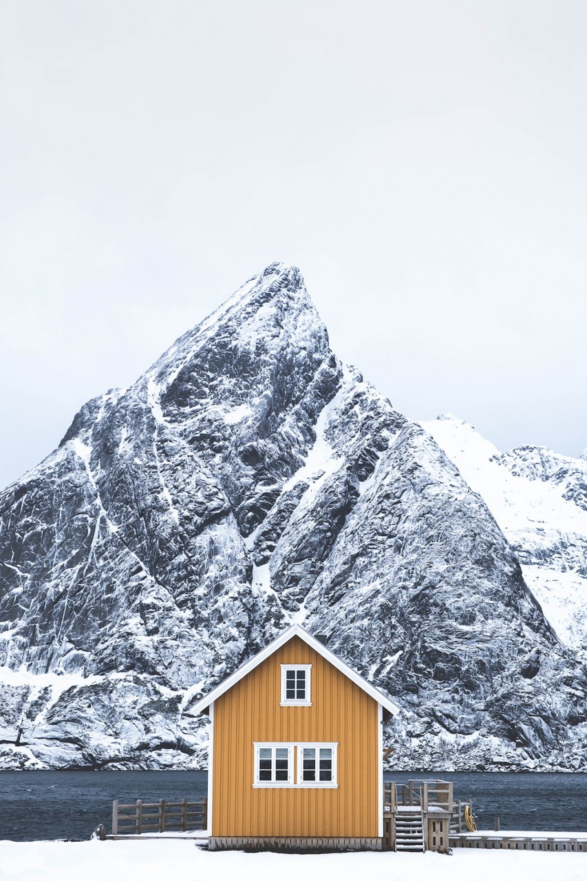 A small yellow hut in the snow in Sakrisoy, Norway.