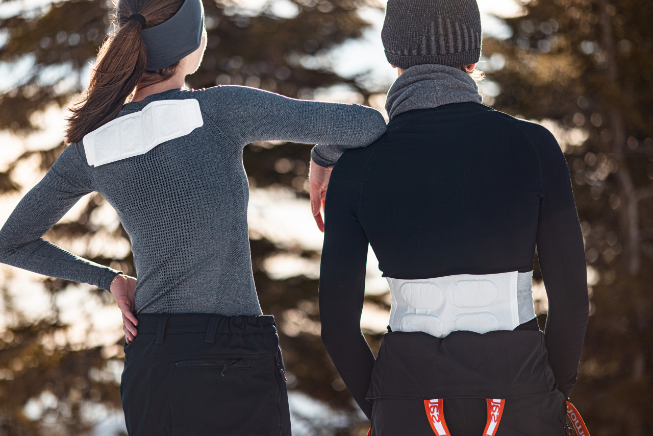 Man and woman with air activated warmers at lower back and shoulders
